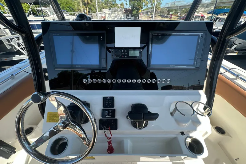 Slide: The Image of 2021 Key West 263 FS boat dashboard with dual Garmin displays and steering wheel. - 22