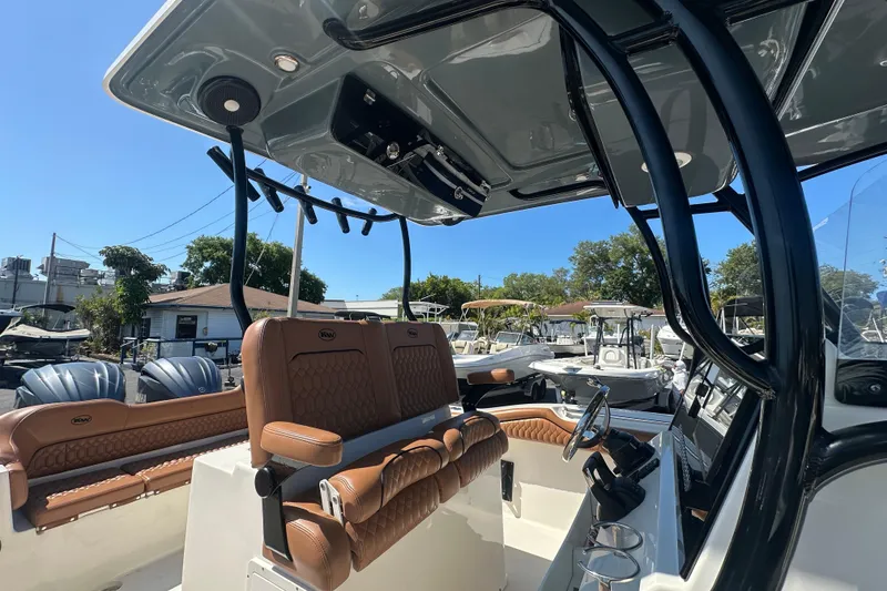 Slide: The Image of 2021 Key West 263 FS boat interior with brown seating and modern helm. - 25