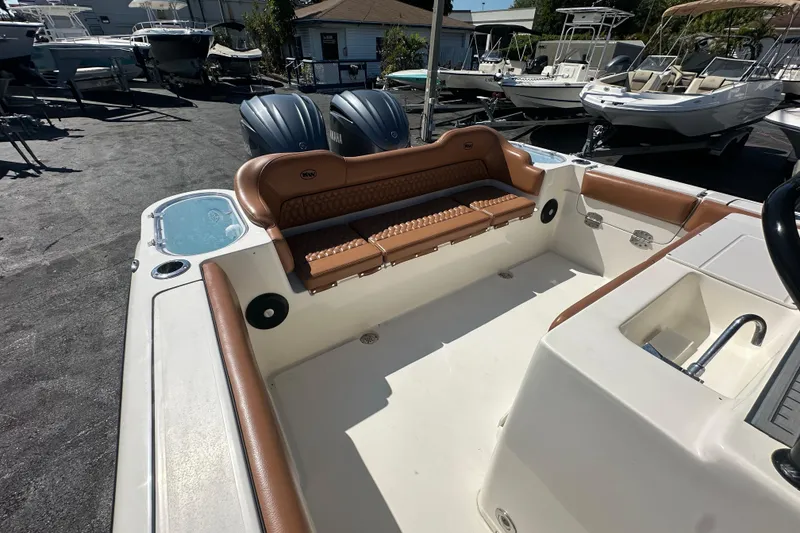 Slide: The Image of 2021 Key West 263 FS boat interior with tan seating and dual engines. - 28