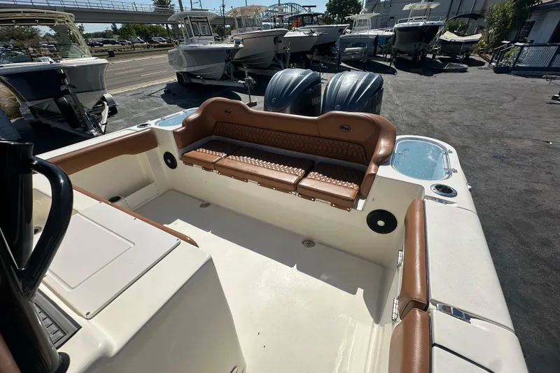 Slide: The Image of 2021 Key West 263 FS boat interior with brown seating and dual outboard motors. - 30