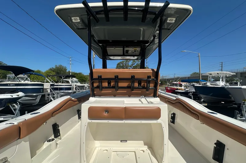 Slide: The Image of 2021 Key West 263 FS boat interior with seating and storage, docked under clear blue sky. - 31