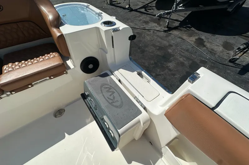 Slide: The Image of 2021 Key West 263 FS boat interior with brown seating and storage compartment. - 34
