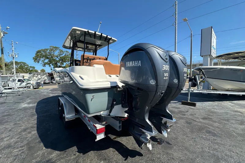 Slide: The Image of 2021 Key West 263 FS boat with dual Yamaha 300 V6 engines, parked on a trailer. - 5