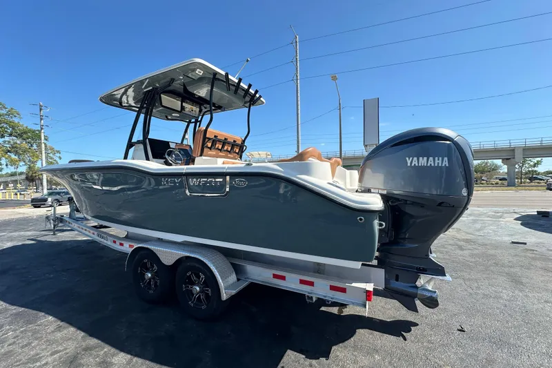 Slide: The Image of 2021 Key West 263 FS boat with Yamaha engine on a trailer, parked outdoors. - 6