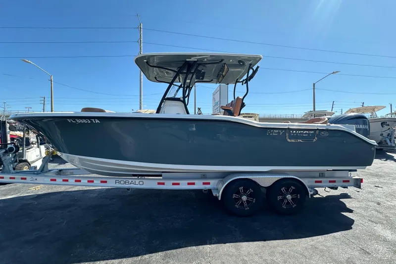 Slide: The Image of 2021 Key West 263 FS boat on a Robalo trailer, parked outdoors. - 7
