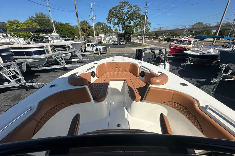 Slide: The Image of 2021 Key West 263 FS boat with tan seating, parked among other boats. - 9
