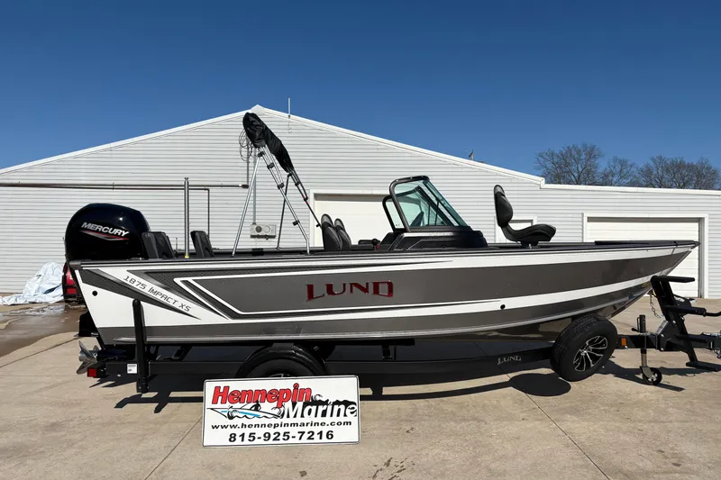 The Image of 2026 Lund 1875 Impact XS Sport boat on trailer at Hennepin Marine dealership. - 1