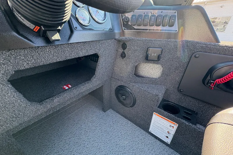 Slide: The Image of 2026 Lund 1875 Impact XS Sport boat dashboard with controls and storage compartments. - 21