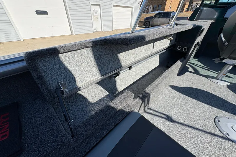 Slide: The Image of 2026 Lund 1875 Impact XS Sport boat interior with open storage compartment. - 27