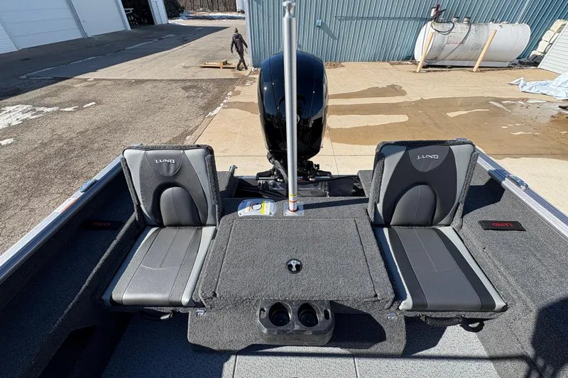 Slide: The Image of 2026 Lund 1875 Impact XS Sport boat interior with two seats and motor view. - 28