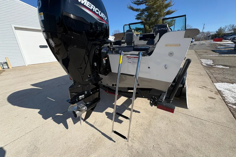 Slide: The Image of 2026 Lund 1875 Impact XS Sport boat with Mercury outboard motor and ladder. - 36