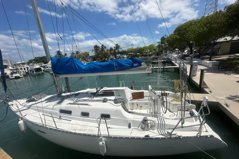 The Image of 2006 Beneteau Oceanis Clipper 323 sailboat docked at marina under blue sky. - 0