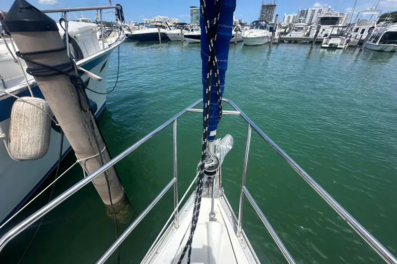 Slide: The Image of Bow view of 2006 Beneteau Oceanis Clipper 323 docked in a marina. - 17