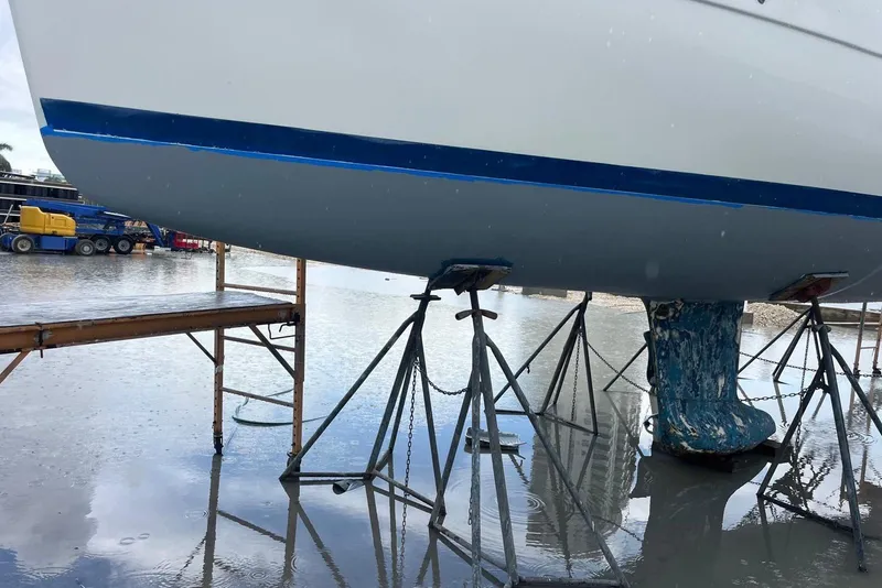 Slide: The Image of 2006 Beneteau Oceanis Clipper 323 sailboat on stands in a wet dockyard. - 21