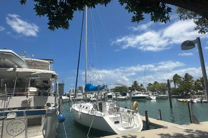 Slide: The Image of 2006 Beneteau Oceanis Clipper 323 docked in a sunny marina with clear skies. - 25