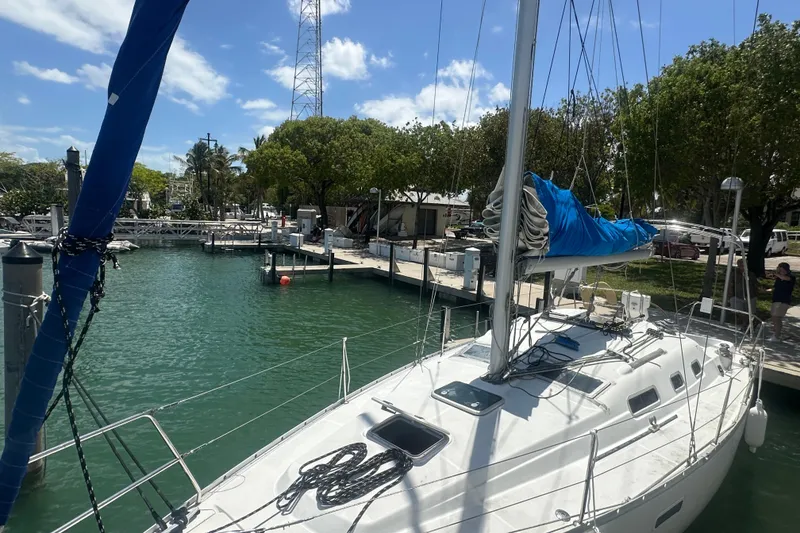 Slide: The Image of Sailboat Beneteau Oceanis Clipper 323, 2006 model, docked in a sunny marina. - 3