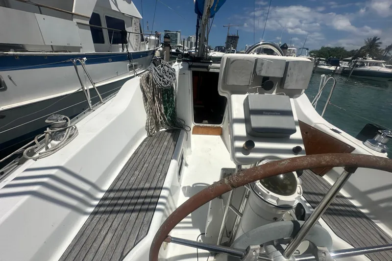 Slide: The Image of 2006 Beneteau Oceanis Clipper 323 sailboat cockpit with steering wheel and marina view. - 39
