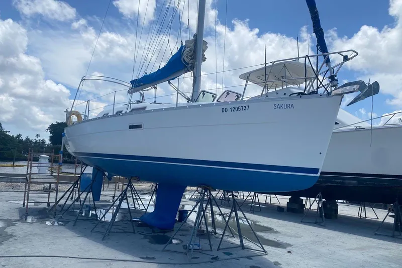 Slide: The Image of 2006 Beneteau Oceanis Clipper 323 sailboat on stands, clear sky background. - 4