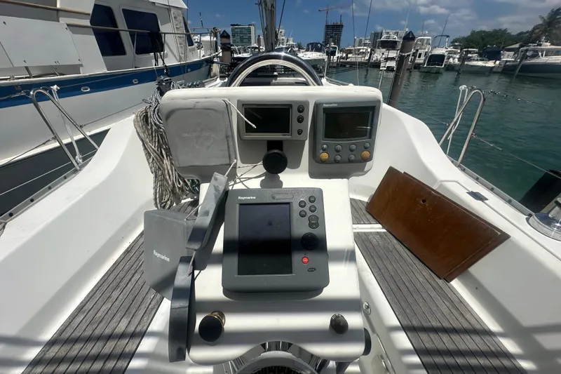 Slide: The Image of Cockpit of 2006 Beneteau Oceanis Clipper 323 with navigation equipment in marina setting. - 40