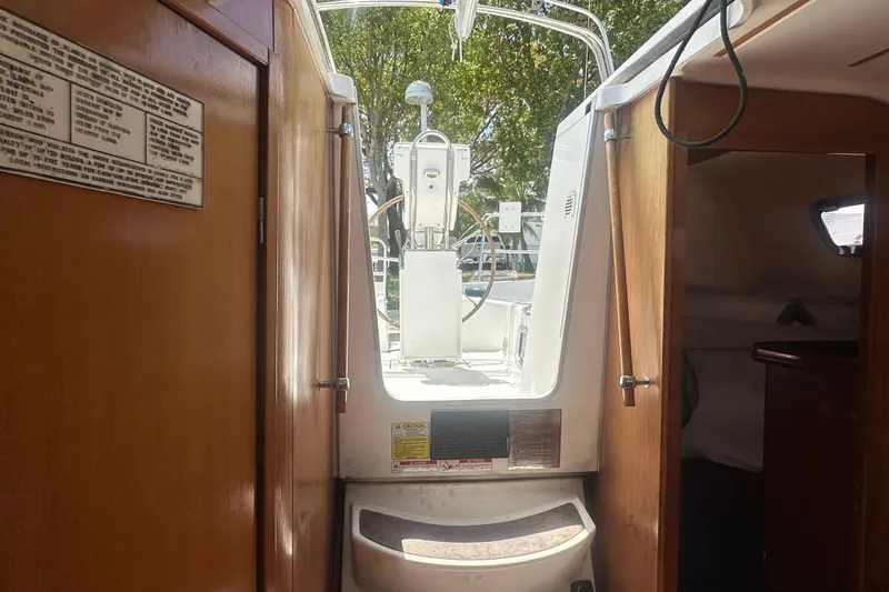 Slide: The Image of Interior view of 2006 Beneteau Oceanis Clipper 323 sailboat, showing cockpit and cabin entrance. - 52