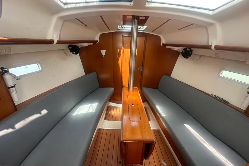 Slide: The Image of Interior of 2006 Beneteau Oceanis Clipper 323 sailboat with wooden finishes and seating. - 56