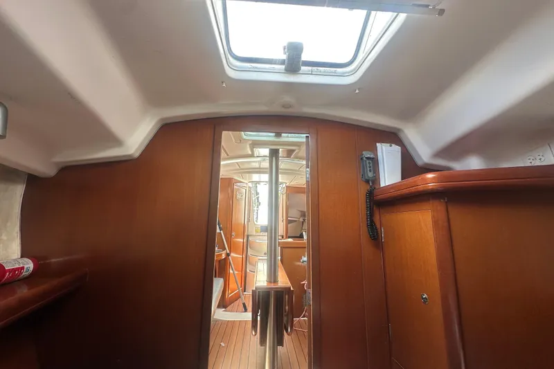 Slide: The Image of Interior view of 2006 Beneteau Oceanis Clipper 323 sailboat, featuring wooden cabinetry and natural light. - 65
