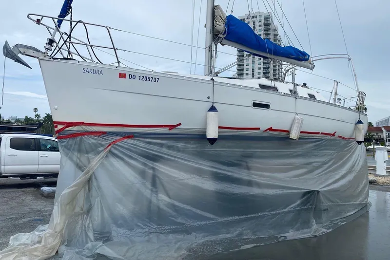 Slide: The Image of 2006 Beneteau Oceanis Clipper 323 sailboat on land, wrapped for maintenance. - 7