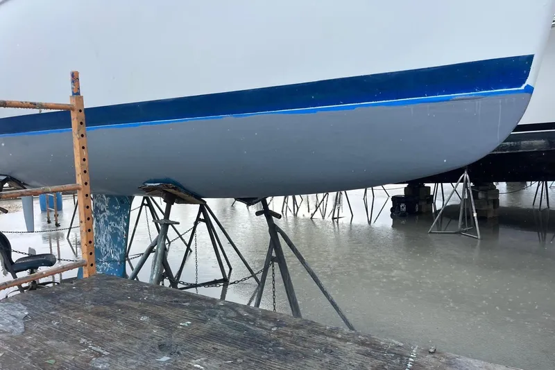Slide: The Image of Beneteau Oceanis Clipper 323 sailboat on stands, 2006 model, in a boatyard. - 9