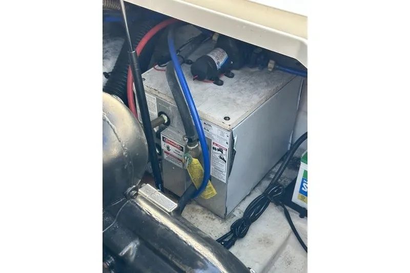 Slide: The Image of Engine compartment of a 2010 Sea Ray 240 Sundancer with visible wiring and components. - 12