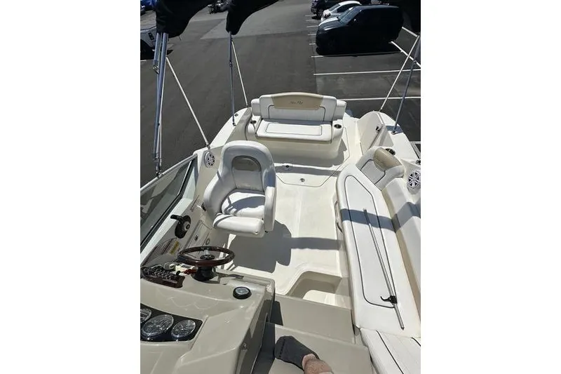 Slide: The Image of 2010 Sea Ray 240 Sundancer boat interior with seating and steering wheel. - 14