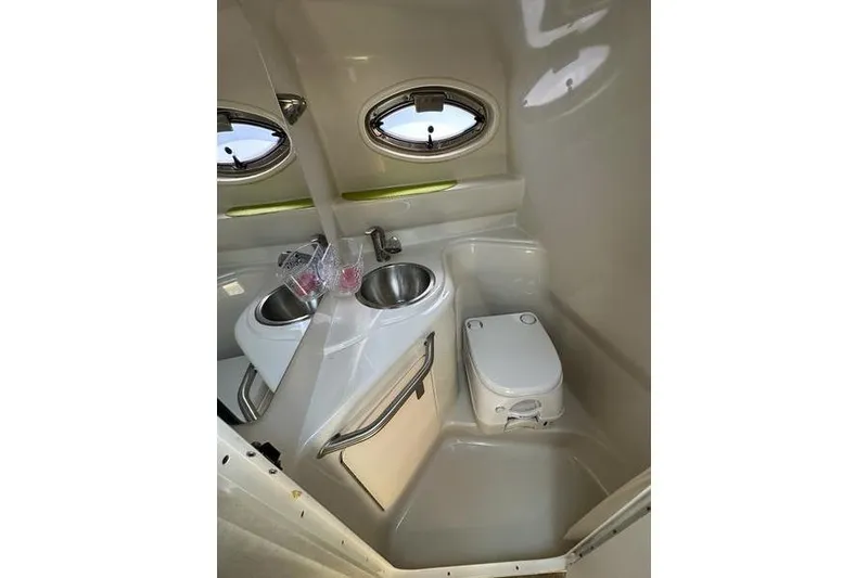 Slide: The Image of Compact bathroom in 2010 Sea Ray 240 Sundancer boat with sink and toilet. - 15