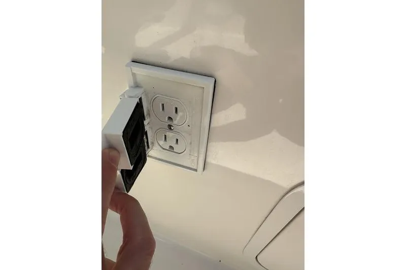 Slide: The Image of Electrical outlet on a 2010 Sea Ray 240 Sundancer boat interior. - 17