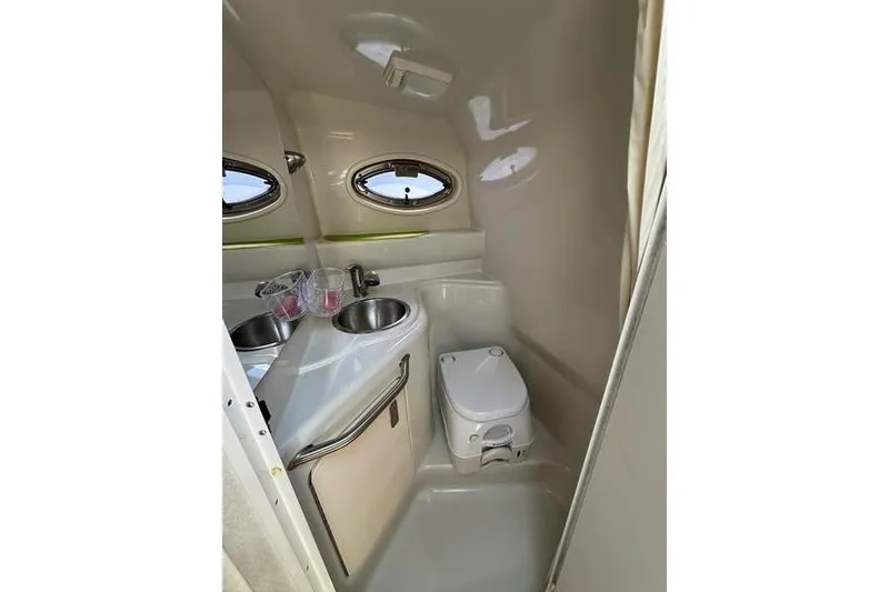 Slide: The Image of Interior of 2010 Sea Ray 240 Sundancer boat bathroom with sink and toilet. - 19