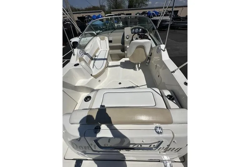 Slide: The Image of 2010 Sea Ray 240 Sundancer boat interior with seating and steering wheel. - 20