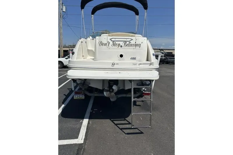 Slide: The Image of 2010 Sea Ray 240 Sundancer boat with "Don't Stop Believing" text on the stern. - 23