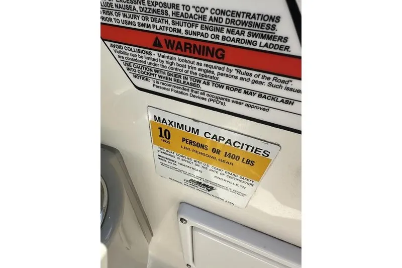 Slide: The Image of Warning and capacity labels on 2010 Sea Ray 240 Sundancer boat. - 24