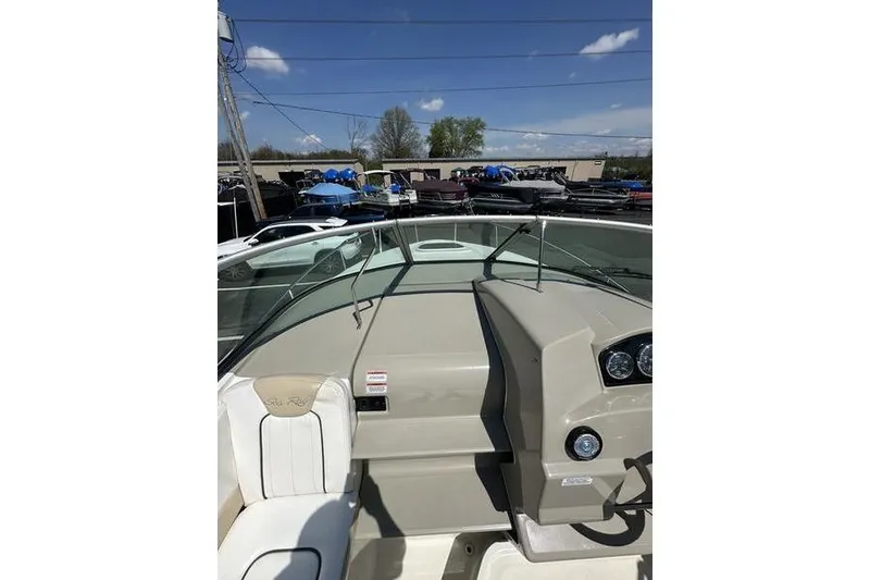 Slide: The Image of 2010 Sea Ray 240 Sundancer boat dashboard under clear blue sky. - 27