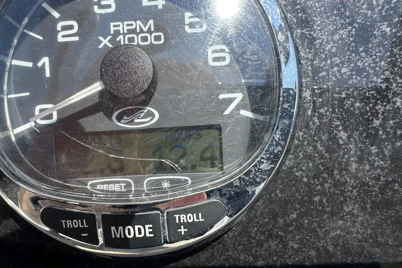 Slide: The Image of Close-up of a Sea Ray 240 Sundancer 2010 tachometer displaying RPM and hours. - 6