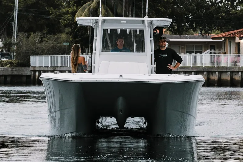 Slide: The Image of Manufacturer Provided Image: 2021 Invincible 35 Catamaran on water with three people onboard. - 2