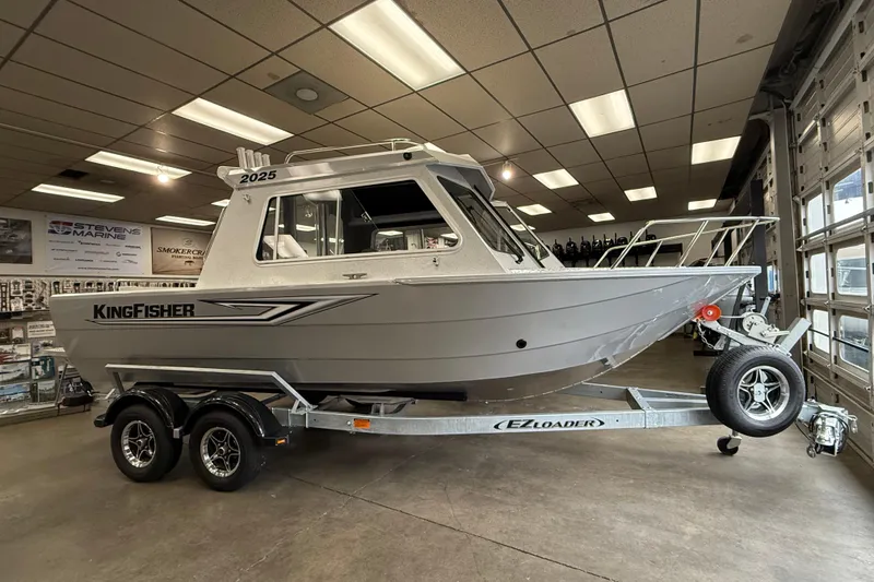 The Image of KingFisher 2025 Escape HT boat on trailer in showroom. - 1