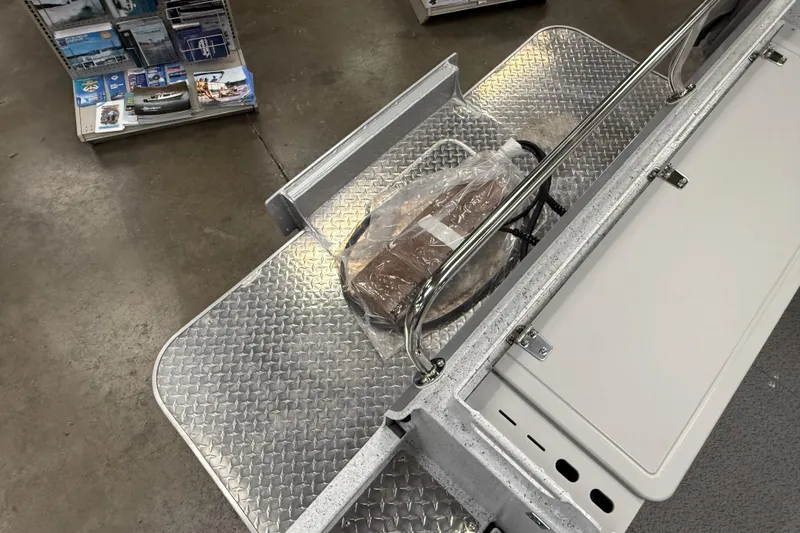 Slide: The Image of Diamond plate flooring on a 2025 KingFisher Escape HT boat, showcasing storage and railing. - 10