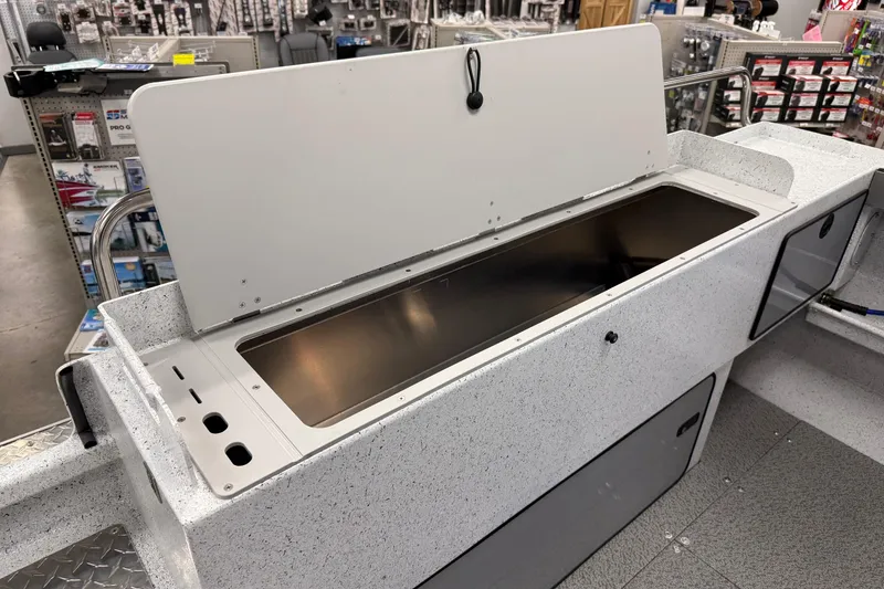 Slide: The Image of KingFisher 2025 Escape HT boat interior with open storage compartment in a showroom. - 11