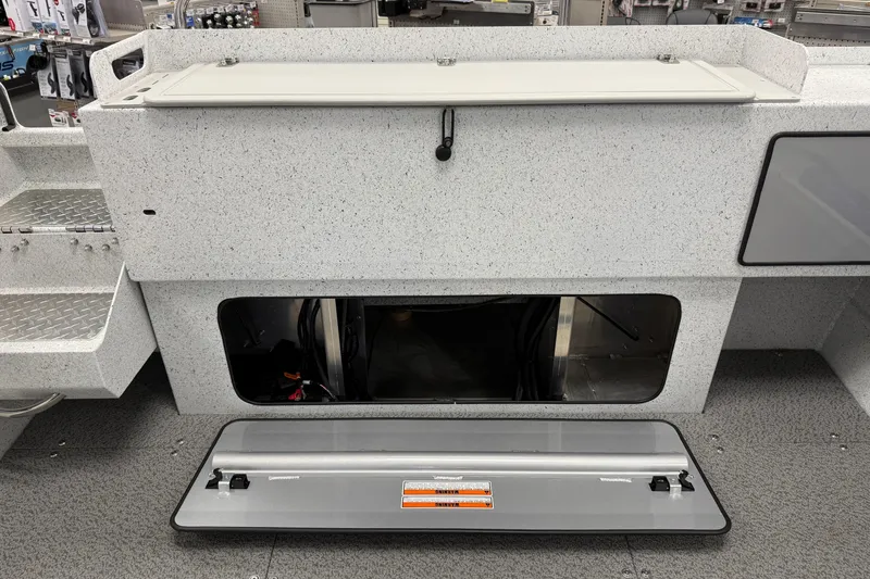 Slide: The Image of Interior view of 2025 KingFisher Escape HT boat storage compartment with open hatch. - 12