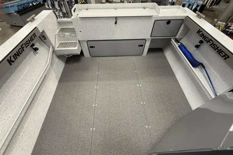 Slide: The Image of Interior of 2025 KingFisher Escape HT boat, featuring spacious deck and storage compartments. - 13