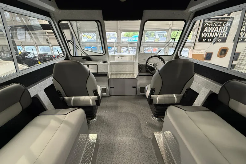 Slide: The Image of Interior of 2025 KingFisher Escape HT boat with modern seating and steering console. - 14