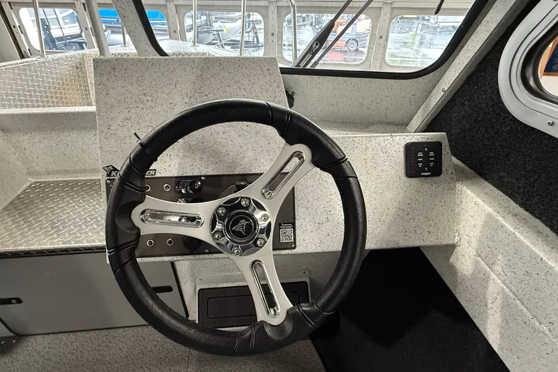 Slide: The Image of Steering wheel of 2025 KingFisher Escape HT boat, featuring modern dashboard design. - 17