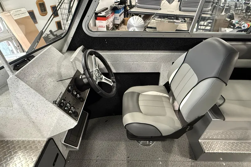 Slide: The Image of Interior of 2025 KingFisher Escape HT boat, featuring steering wheel and captain's chair. - 19