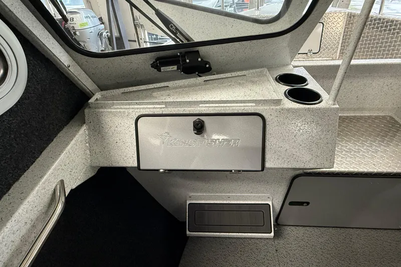 Slide: The Image of Interior of 2025 KingFisher Escape HT boat with storage compartment and cup holders. - 21