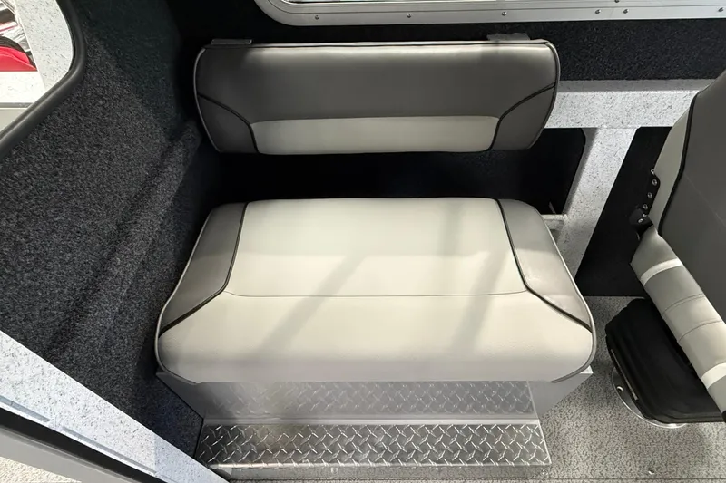 Slide: The Image of Interior seating of 2025 KingFisher Escape HT boat, featuring cushioned seats and diamond plate flooring. - 22