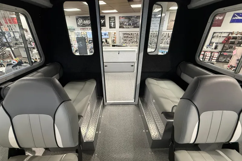 Slide: The Image of Interior of 2025 KingFisher Escape HT boat, featuring modern seating and spacious cabin design. - 28